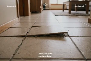Fenomena keramik lantai terangkat atau popping yang sering terjadi pada rumah.
