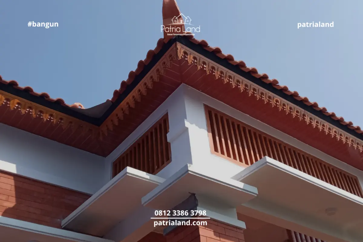 Detail keindahan atap rumah Joglo Jawa modern dengan wuwungan tanah liat dan lisplang kayu ukir bernuansa tradisional.